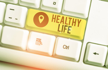 Text sign showing Healthy Life. Business photo showcasing one that helps to keep and improve showing s is health or condition White pc keyboard with empty note paper above white background key copy