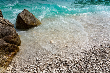 rocky scenic mali bok orlec beach on cres island croatia with turquoise crystal clear sea and waves