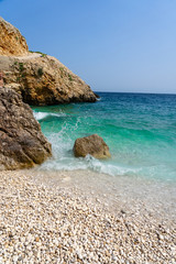 rocky scenic mali bok orlec beach on cres island croatia with turquoise crystal clear sea and waves