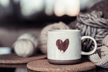 Cozy Autumn background with a beautiful Cup with a heart.