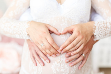 Waiting of baby-girl, mammy`s belly in lace dress closeup