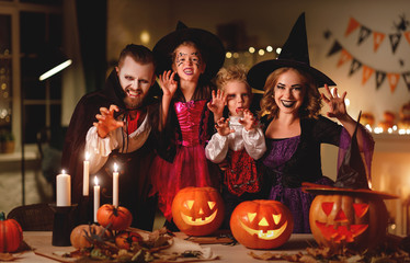 happy family mother father and children in costumes and makeup on  Halloween.
