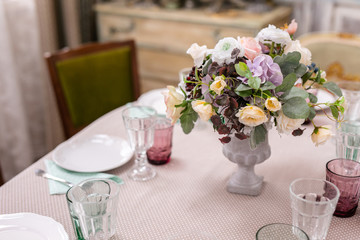 bouquet of flowers in a vase at the wedding table