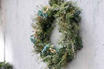 modern Christmas wreath. stylish rustic christmas wreath with pine cones,fir branches,snow, hanging...