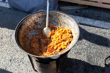 Traditional Uzbek pilaf in a large cauldron