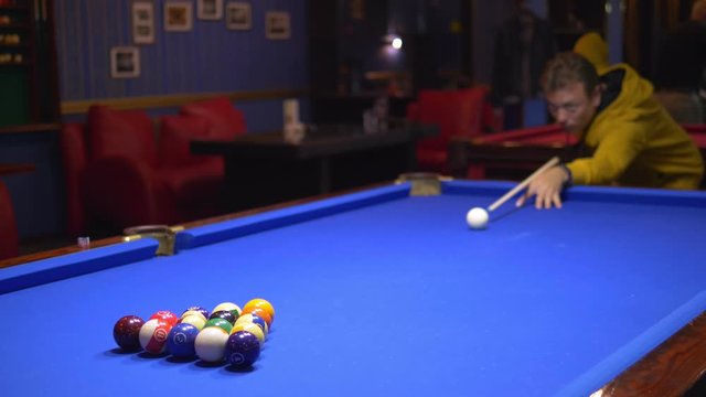 fashionable guy puts on a pool table A full set of billiards in a triangular frame on a green frieze. copy space