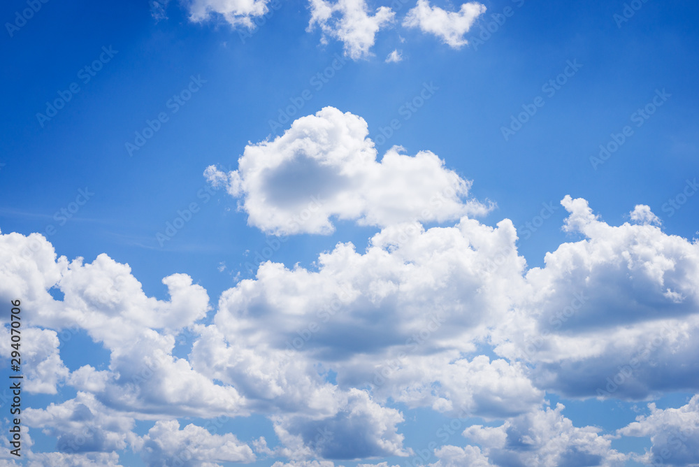 Sticker Fluffy clouds against sunlight in sky