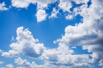 Naklejka na ściany i meble Dramatic cloudscape of big white clouds in sky during daytime