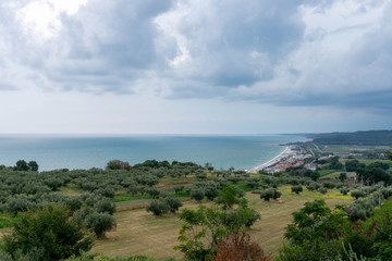 Fototapeta na wymiar Landscape with countryside in the foreground, sea in the background and cloudy sky