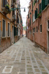 Narrow street with colorful houses in the city of Venice