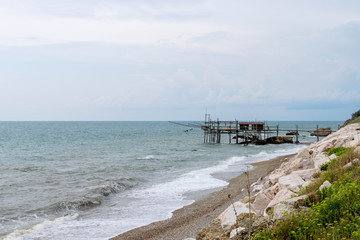 Stilt house on the rough sea with a blue sky and sea in Abruzzo