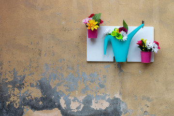 Wall decoration with flowers in small hanging vases
