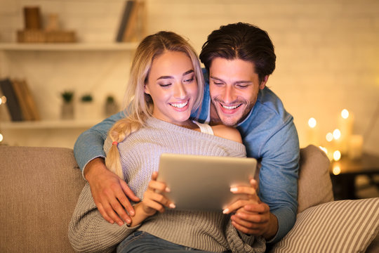 Preparation for xmas. Loving couple searching gifts on tablet