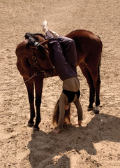 photo a girl stands in her arms leaning on a horse