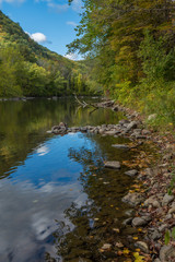 Fototapeta na wymiar River in Cornwall, New England in early fall showing reflections of deep blue fall sky