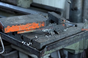 Metal swarfs after drilling, car repair shop