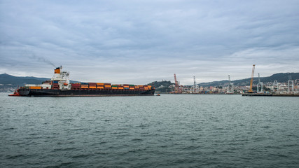 merchant ship docking at the port to unload