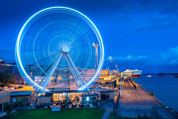 Ferris wheel in Helsinki. Finland. Scandinavia. Cruise port. A glowing Ferris wheel against a dark blue sky. Ferry cruise. Travelling in Europe. Sightseeing In Helsinki.