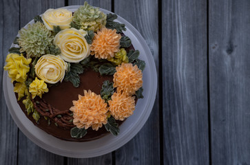 Ganache Buttercream Cake With Piped Buttercream Flowers. Copy space.