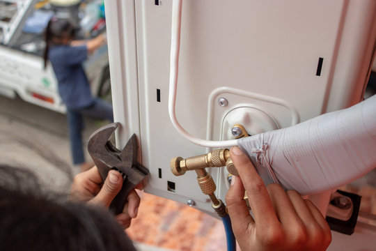 Technicians check the air conditioning refrigerant system