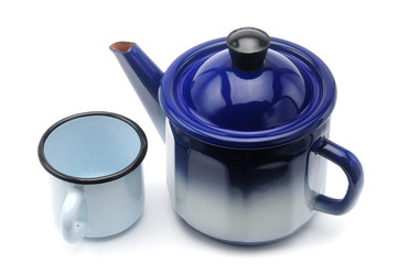 Vintage teapot in blue with a mug on a white background