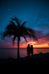 Couple contemplating the sunset at Holbox Island in the Caribbean Ocean of Mexico