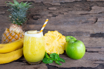 Banana with pineapple and apples smoothies yellow fruit juice, healthy drink delicious in a glass...