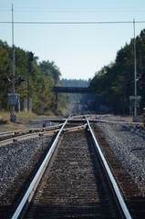 Fototapeta na wymiar Looking down railroad tracks with a switch rail joining