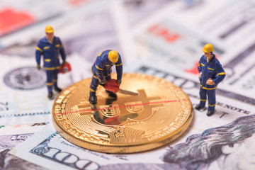 miniature worker cutting bitcoin , halving concept