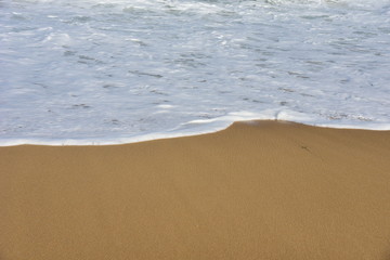 Fototapeta na wymiar soft wave on the sandy beach summer Time concept,copy space.
