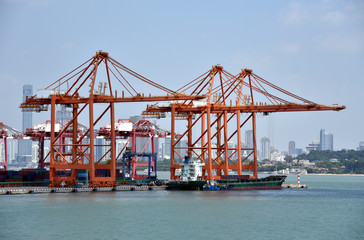 View on the container terminal and gantry cranes loading containers on the cargo ship in the port of Xiamen, China. 