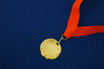Gold medal with red ribbon on blue background