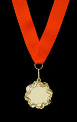 Gold medal with red ribbon isolated on black background