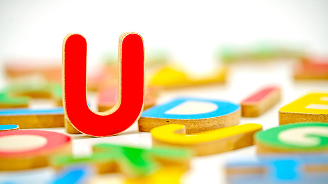 Close up education toys wooden scrabble Alphabet U letters