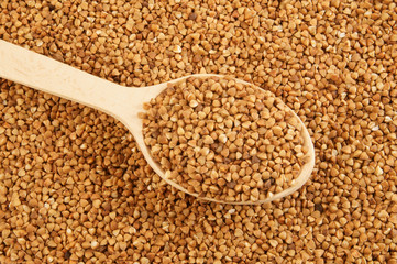 Buckwheat with wooden spoon close up