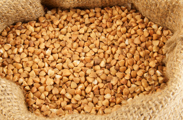 Buckwheat in burlap sack close up
