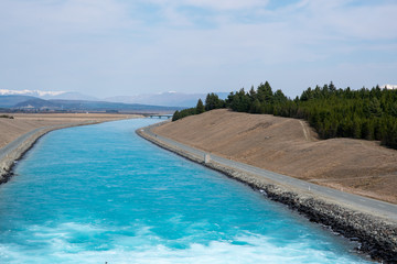 The turquoise waters of Lake Tekapo and its canal in New Zealand