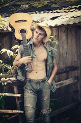 young man in an open denim jacket with a guitar in his hands-a retro portrait in the style of the American Outback