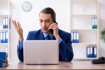 Young male accountant working in the office