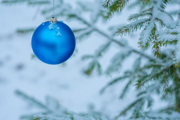  Blue Christmas ball on a snow-covered Christmas tree