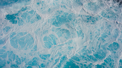 Texture of marine splashes. crashing ocean wave foam structure. Dark blue clear water. Ocean depth.
