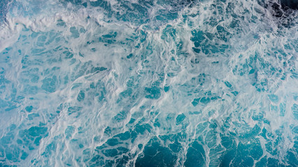 Texture of marine splashes. crashing ocean wave foam structure. Dark blue clear water. Ocean depth.