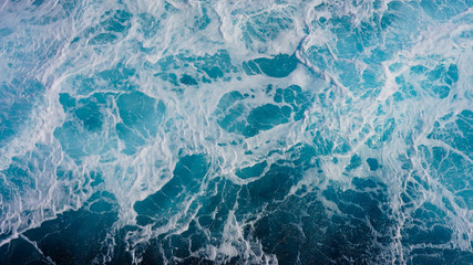 Texture of marine splashes. crashing ocean wave foam structure. Dark blue clear water. Ocean depth.