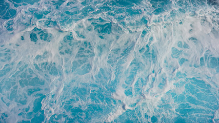 Fototapeta premium Texture of marine splashes. crashing ocean wave foam structure. Dark blue clear water. Ocean depth.
