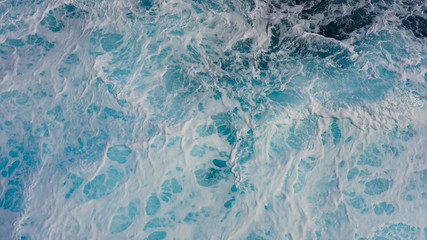 Texture of marine splashes. crashing ocean wave foam structure. Dark blue clear water. Ocean depth.