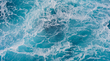 Texture of marine splashes. crashing ocean wave foam structure. Dark blue clear water. Ocean depth.