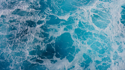 Texture of marine splashes. crashing ocean wave foam structure. Dark blue clear water. Ocean depth.