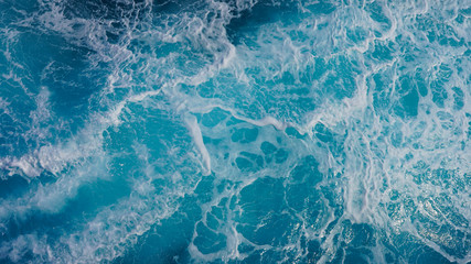 Texture of marine splashes. crashing ocean wave foam structure. Dark blue clear water. Ocean depth.