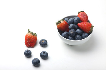 a bowl of strawberry and blueberry isolated on white background