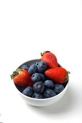 a bowl of strawberry and blueberry isolated on white background
